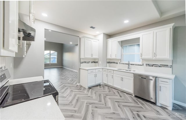 kitchen with range with electric stovetop, sink, white cabinets, and stainless steel dishwasher