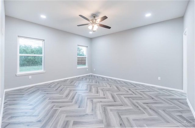 empty room featuring light parquet floors and ceiling fan