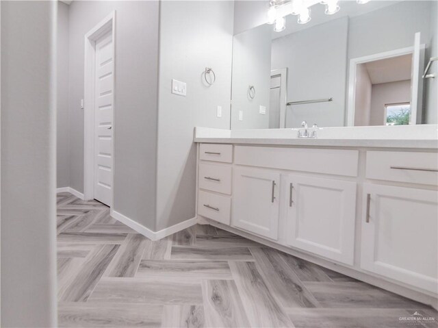 bathroom featuring vanity and parquet flooring