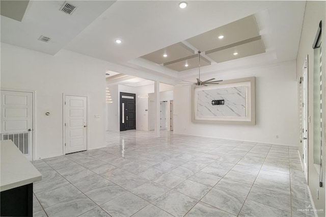 unfurnished room with coffered ceiling, beamed ceiling, and ceiling fan