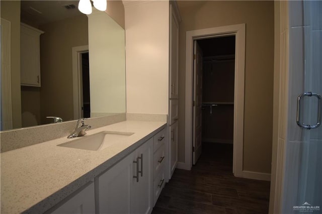 3131 Stark Rd, Weslaco, TX 78596 - bathroom with wood finished floors, vanity, and a shower with door