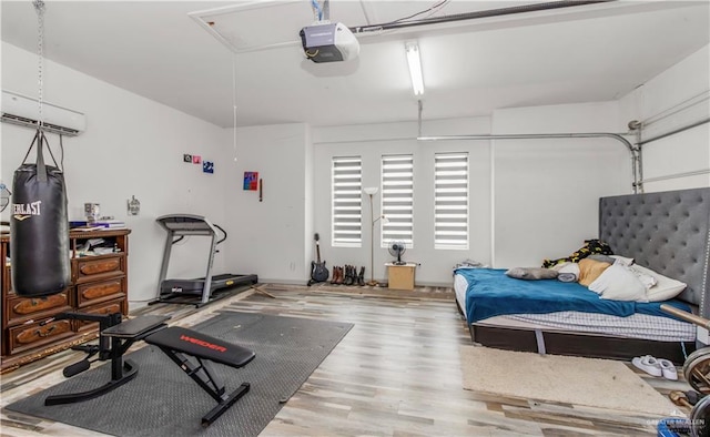 workout area with an AC wall unit and hardwood / wood-style flooring