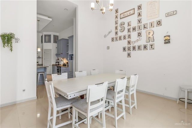 tiled dining room featuring a notable chandelier