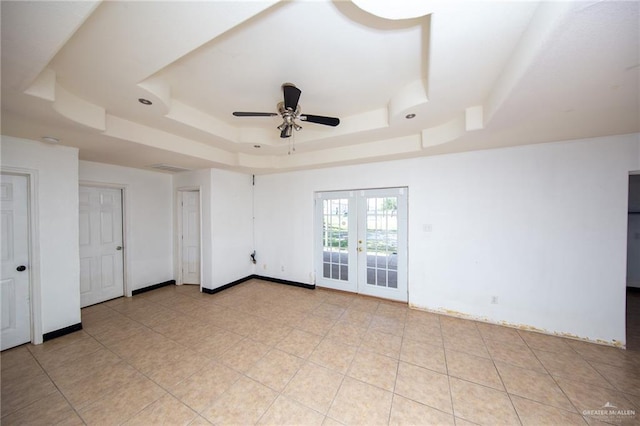 201 E Durango Dr, Pharr, TX 78577 - empty room with light tile patterned floors, a ceiling fan, french doors, and a raised ceiling