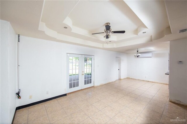 201 E Durango Dr, Pharr, TX 78577 - unfurnished room with a raised ceiling, visible vents, a ceiling fan, a wall unit AC, and french doors