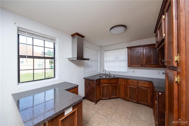 201 E Durango Dr, Pharr, TX 78577 - kitchen featuring wall chimney exhaust hood, a sink, dark stone countertops, brown cabinets, and light tile patterned floors