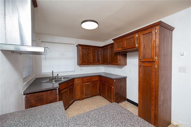 201 E Durango Dr, Pharr, TX 78577 - kitchen featuring dark countertops, brown cabinetry, light tile patterned floors, and a sink