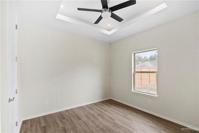 3317 Yellowhammer Ave, Mcallen, TX 78504 - spare room with wood finished floors, ceiling fan, a tray ceiling, baseboards, and recessed lighting