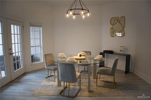 dining space featuring wood-type flooring and french doors