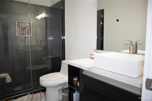 bathroom featuring walk in shower, vanity, and toilet