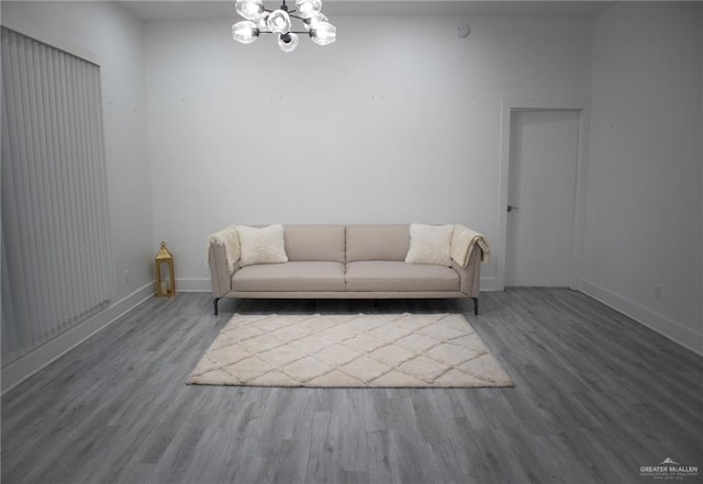 unfurnished living room featuring wood-type flooring and a notable chandelier