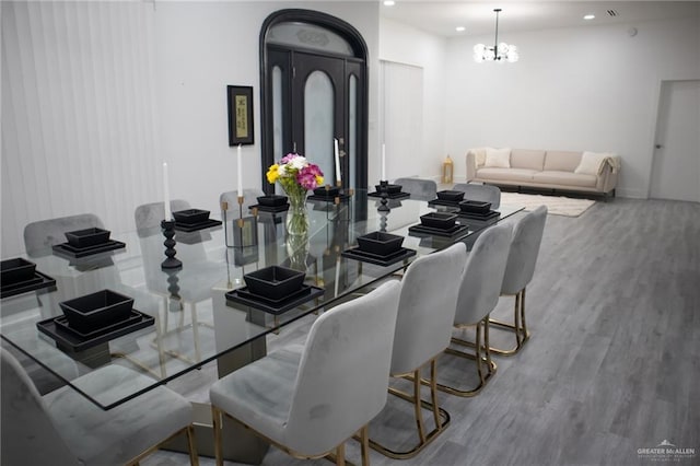 dining room with wood-type flooring and a chandelier