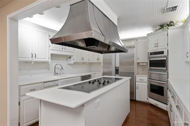 kitchen with island exhaust hood, sink, a center island, dark hardwood / wood-style floors, and white cabinetry