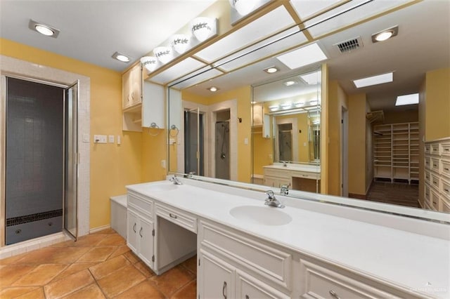 bathroom featuring vanity and an enclosed shower