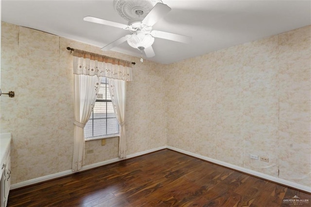 spare room featuring ceiling fan and dark hardwood / wood-style floors