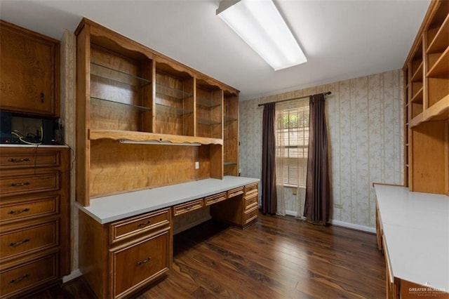 office area with dark hardwood / wood-style flooring and built in desk