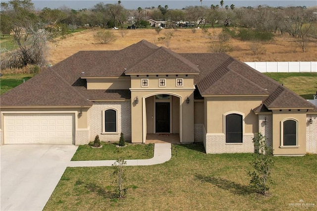 view of front of home featuring a garage and a front lawn