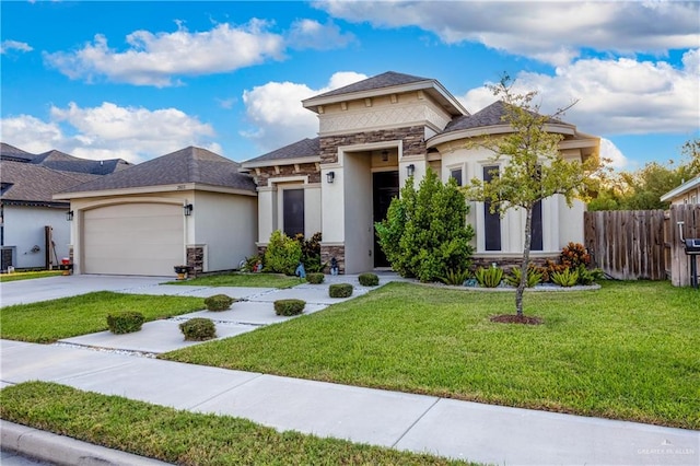 prairie-style house featuring a front lawn and a garage