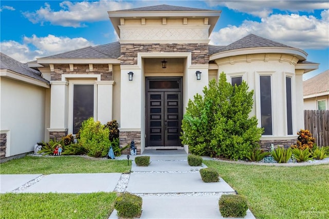 view of exterior entry with a lawn