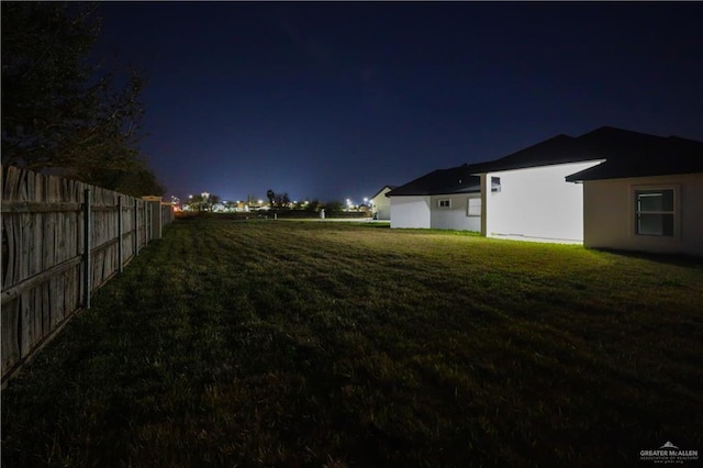 view of yard at twilight