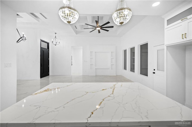 interior space featuring coffered ceiling, ceiling fan with notable chandelier, and beam ceiling