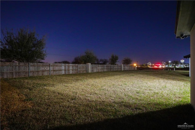 view of yard at dusk