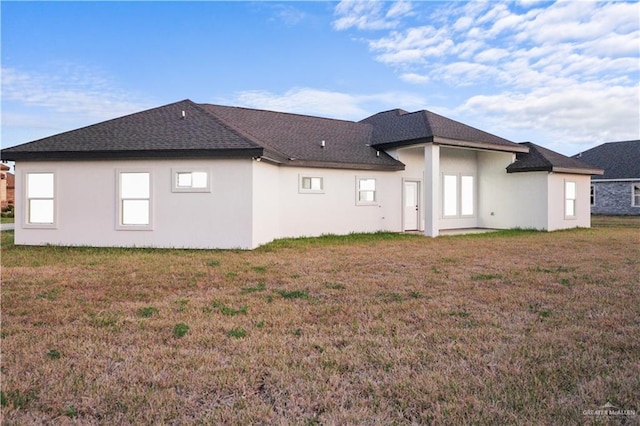 rear view of property with a lawn