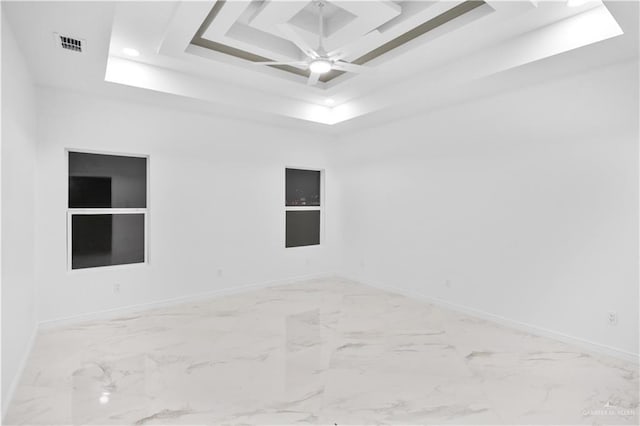 empty room featuring a tray ceiling