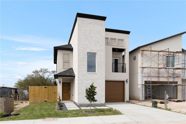 contemporary home with a garage and a balcony