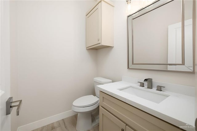 bathroom with vanity, wood-type flooring, and toilet