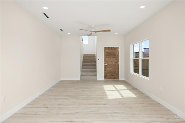 unfurnished room with ceiling fan and light wood-type flooring