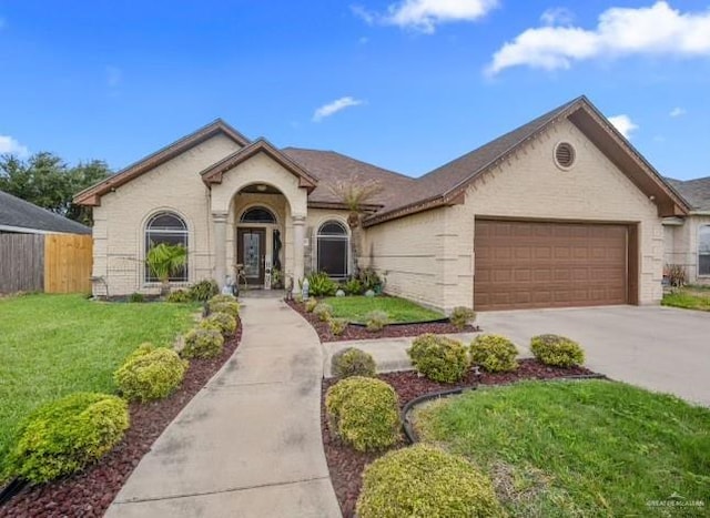 view of front of property featuring concrete driveway, fence, a front lawn, and a garage