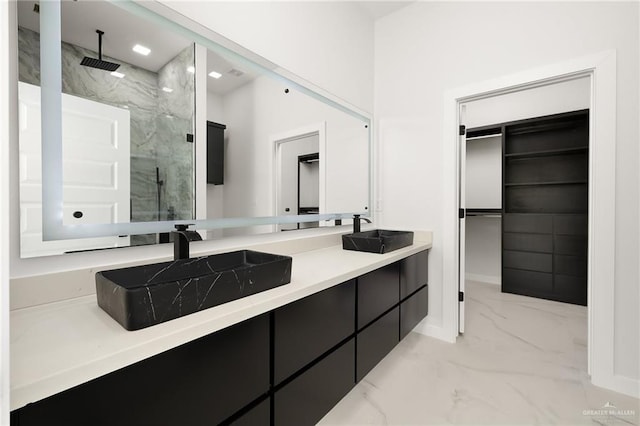 bathroom with vanity and tiled shower