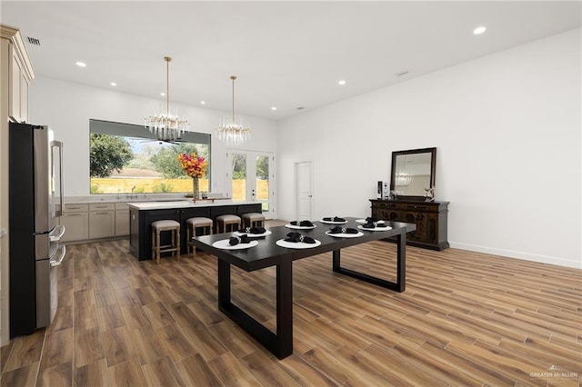 playroom featuring dark hardwood / wood-style flooring, a chandelier, and french doors