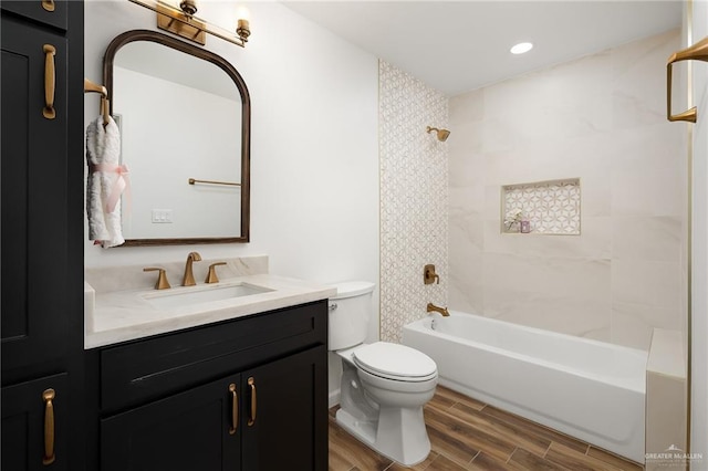 full bathroom with toilet, vanity, and tiled shower / bath combo