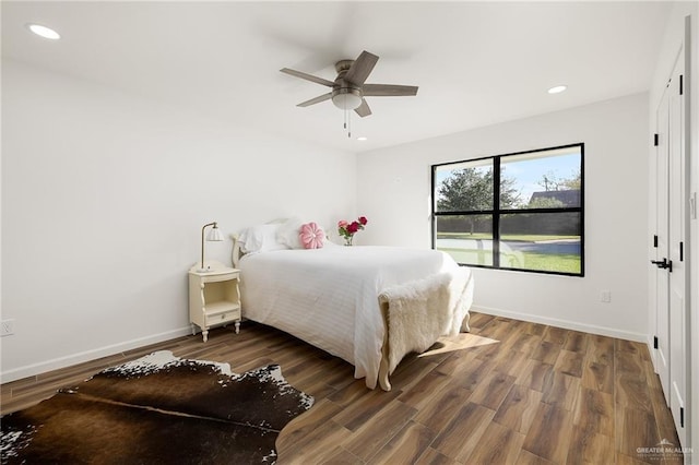 bedroom featuring ceiling fan and dark wood-type flooring