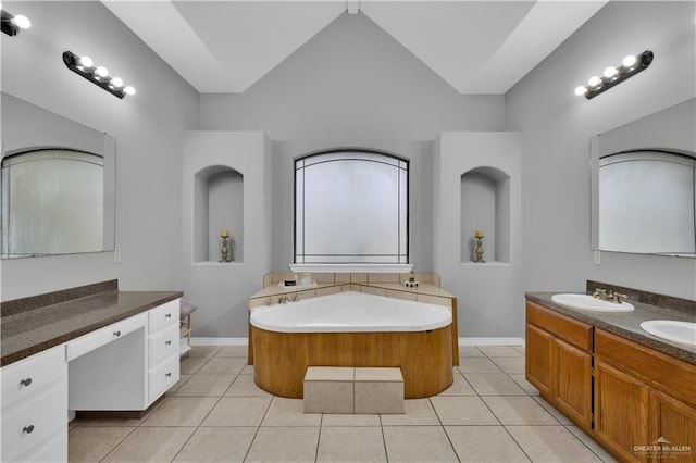 bathroom with lofted ceiling, tile patterned flooring, vanity, and baseboards