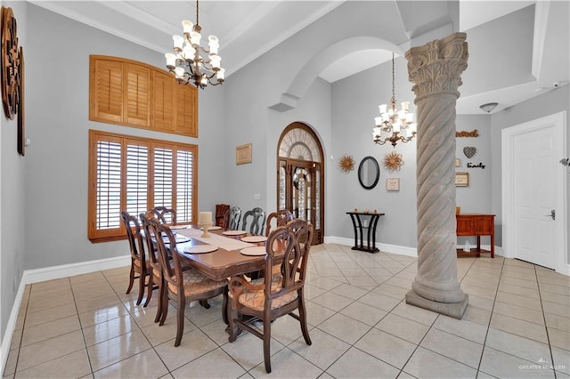 dining room featuring arched walkways, light tile patterned flooring, a notable chandelier, and baseboards