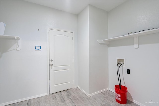 clothes washing area featuring hookup for a washing machine and light wood-type flooring