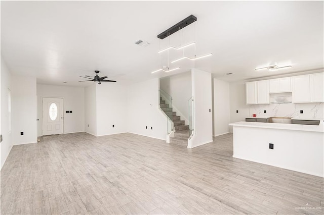 unfurnished living room with ceiling fan and light hardwood / wood-style flooring