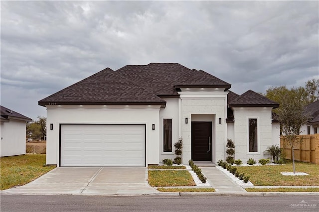 view of front of home with a garage and a front lawn