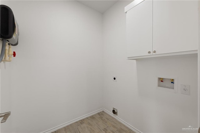 laundry room featuring cabinets, light hardwood / wood-style flooring, washer hookup, and hookup for an electric dryer