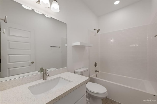 full bathroom featuring bathtub / shower combination, vanity, and toilet