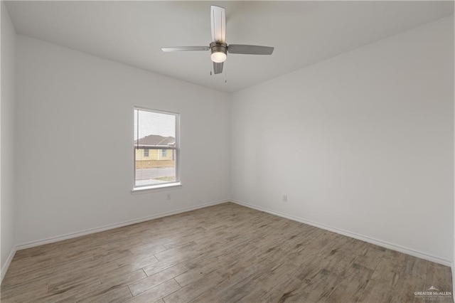 empty room with ceiling fan and light hardwood / wood-style floors