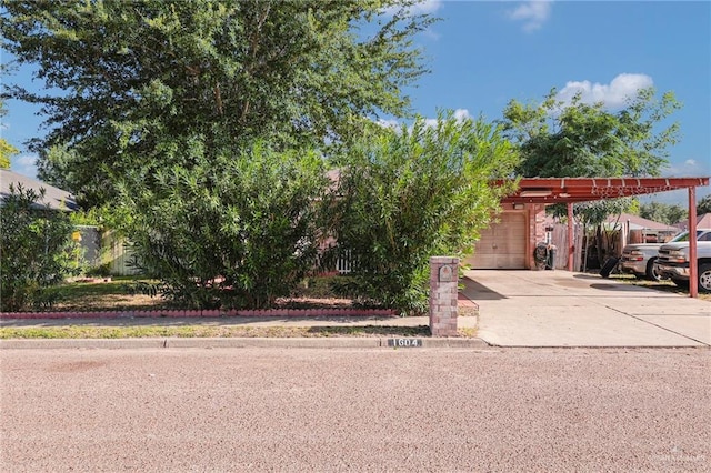 1604 E Kennedy Ave, Alton, TX 78573 - obstructed view of property with concrete driveway and a garage