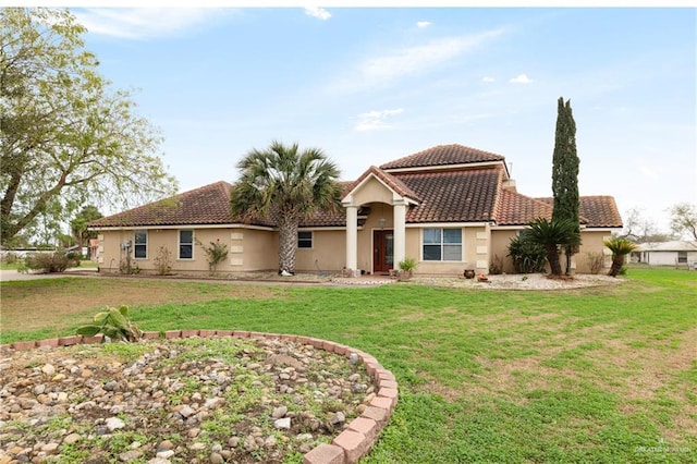 mediterranean / spanish-style home with a front lawn