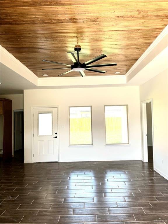 spare room featuring dark hardwood / wood-style floors, a tray ceiling, ceiling fan, and wood ceiling