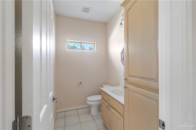 bathroom with vanity, tile patterned floors, and toilet