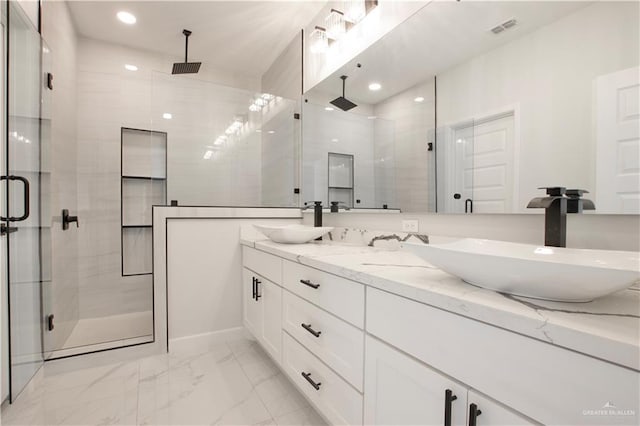 bathroom with vanity and a shower with door