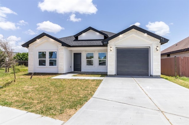 405 S 23rd St, Hidalgo, TX 78537 - view of front of property featuring a garage, driveway, stone siding, and roof with shingles